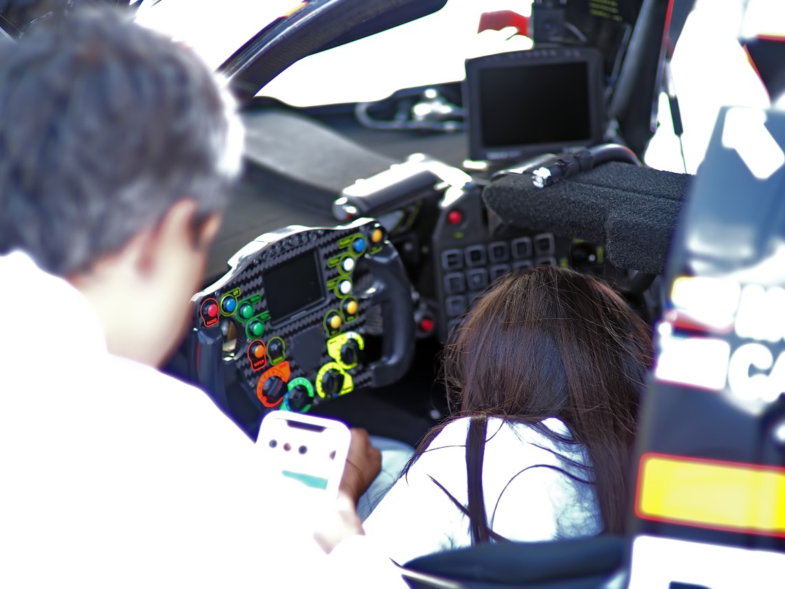 #6 Penske Acura driver Juan Montoya showing his office to one of