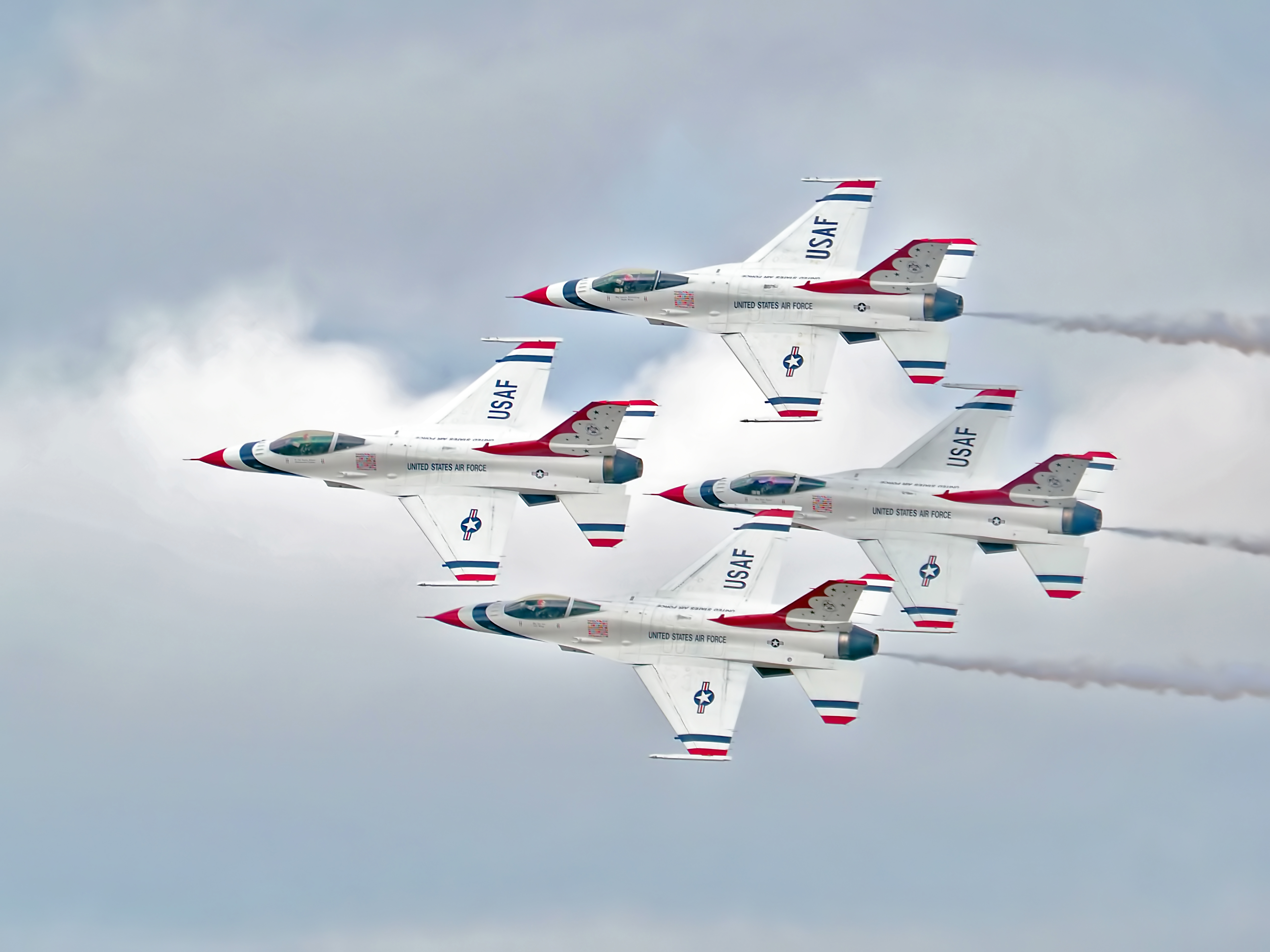 Thunderbirds Diamond formation featuring the F-16 Fight Falcon aircraft.